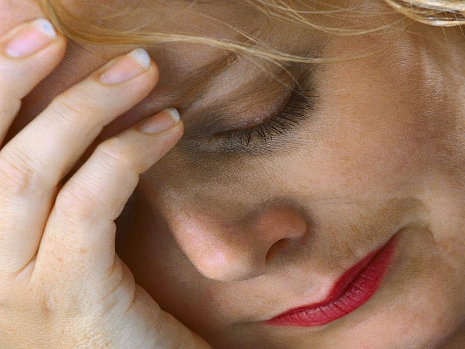 woman face showing signs of stress and worry