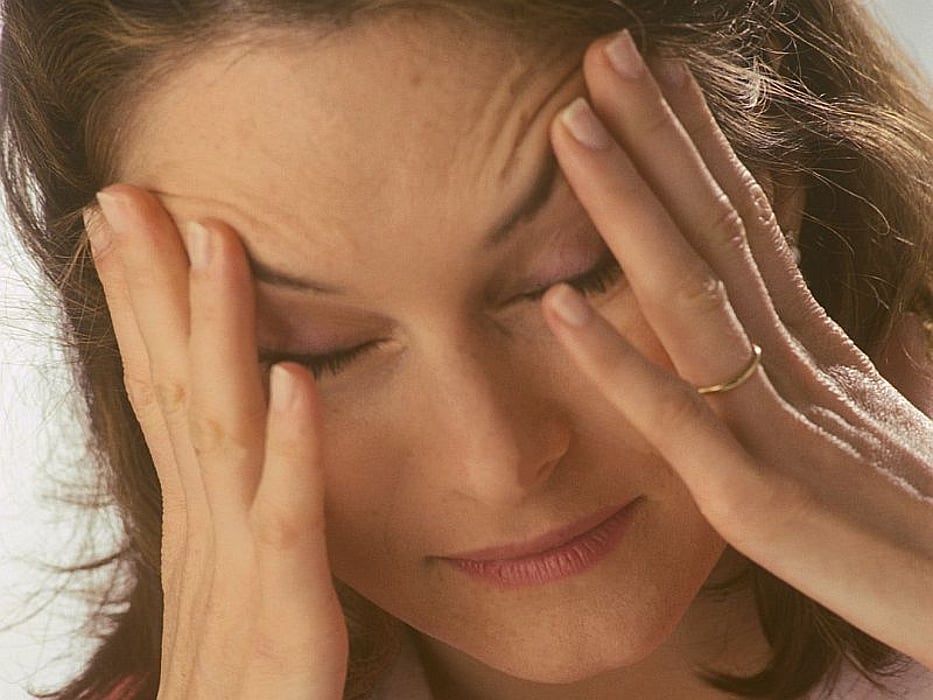 woman holding her head