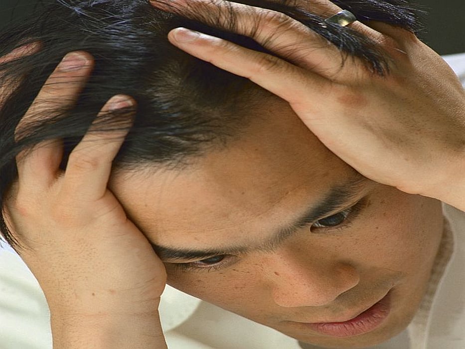 man holding his head