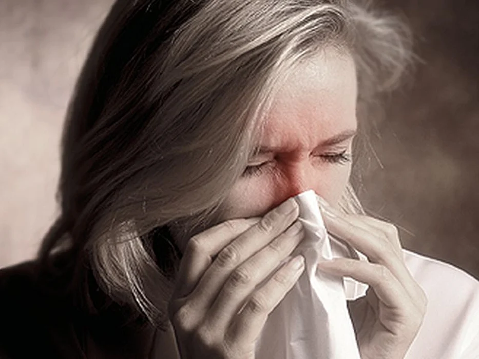 woman blowing nose