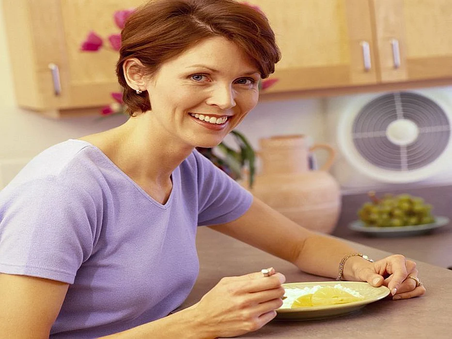 woman eating from a plate