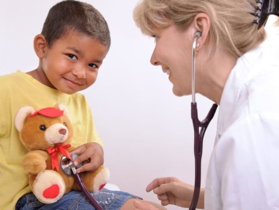 child with teddy bear and nurse