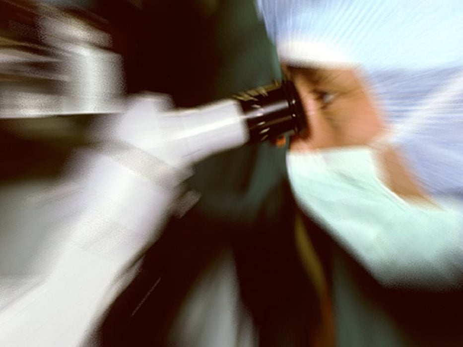 man using microscope