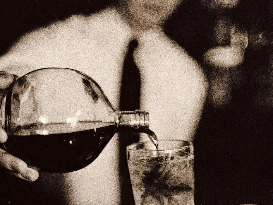 man pouring into the glass