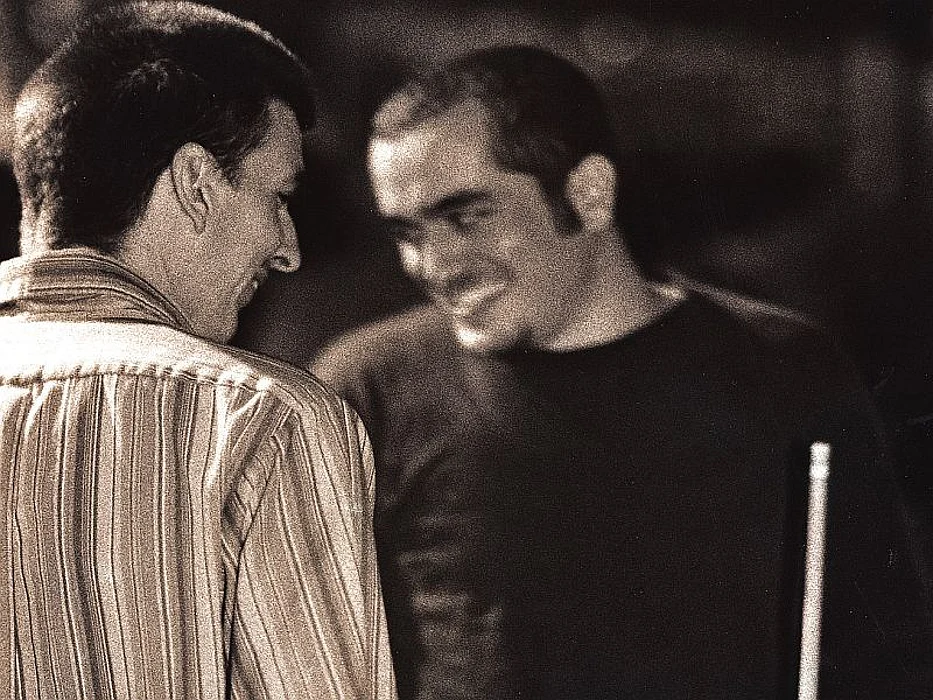two men talking and smiling