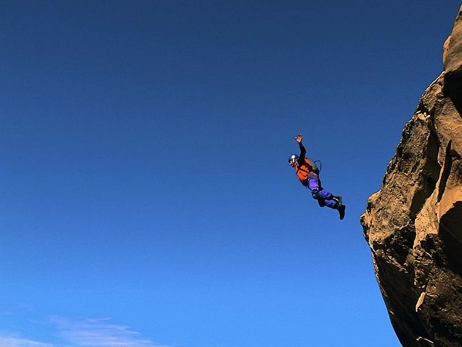 a man cliff jumping