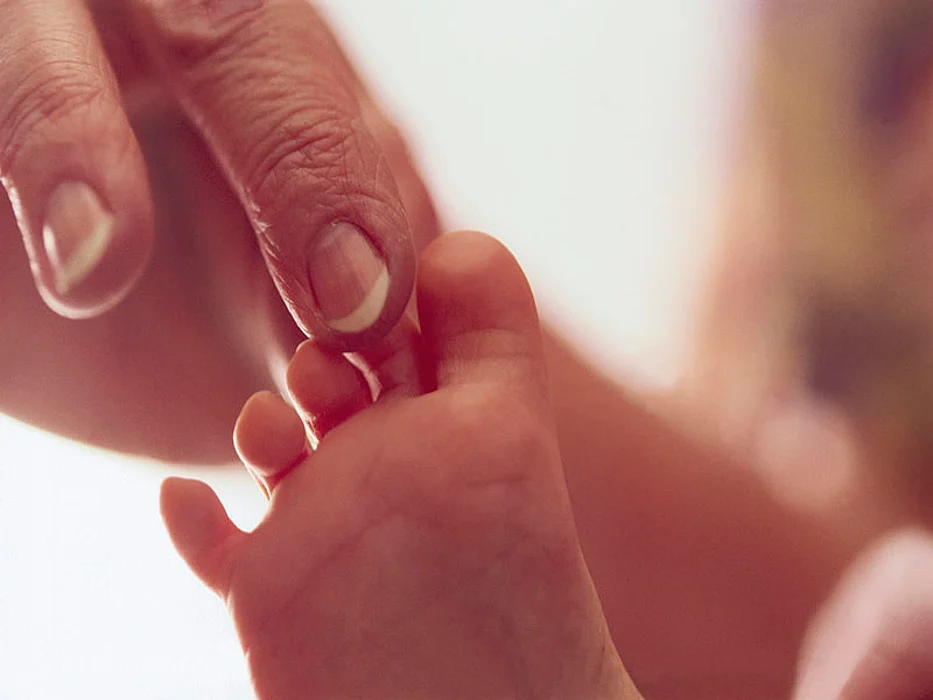 touching baby\'s foot