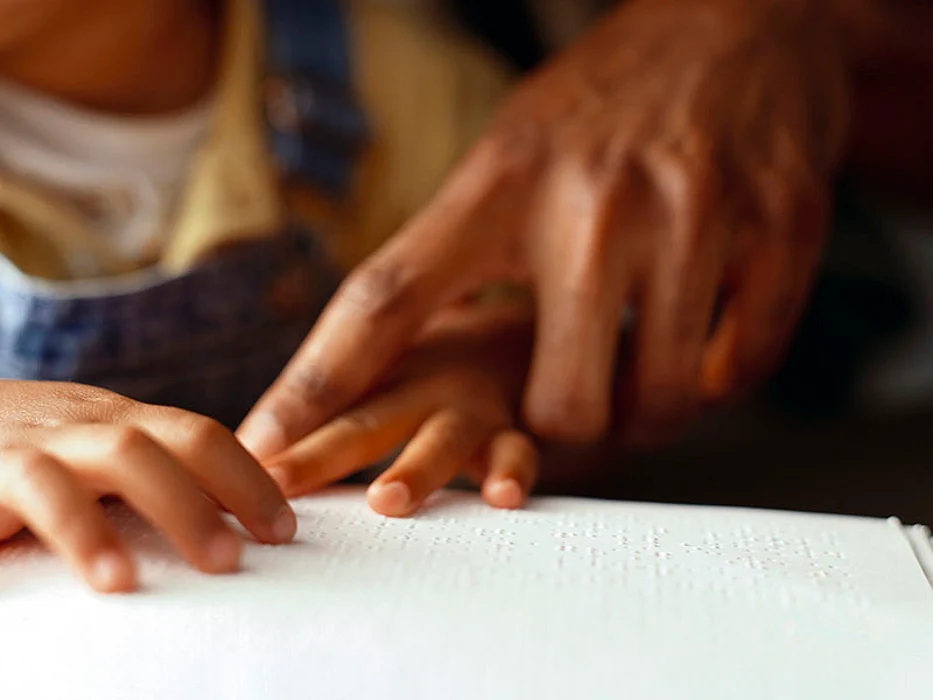 man touching baby\'s hand