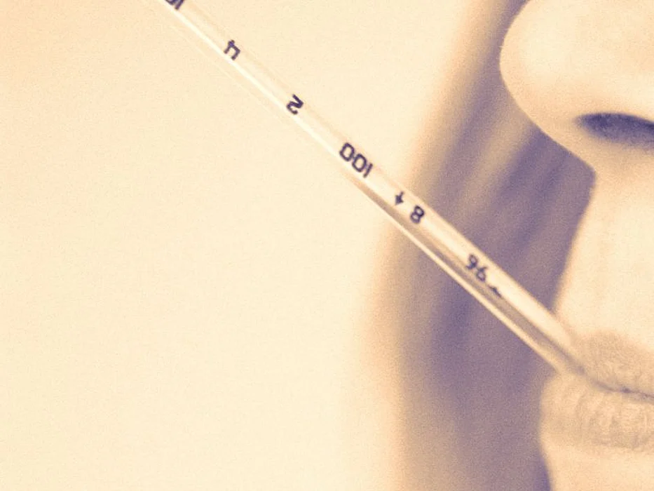 woman with thermometer in mouth