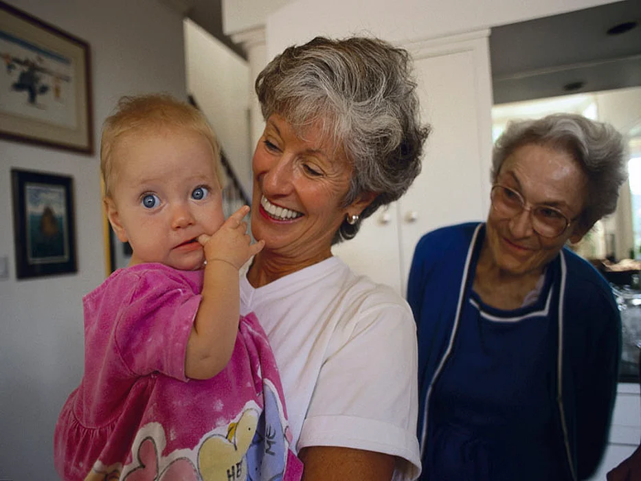 grandmother holding granddaughter