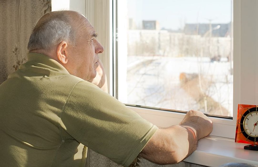 man with alzheimer\'s stares out of window