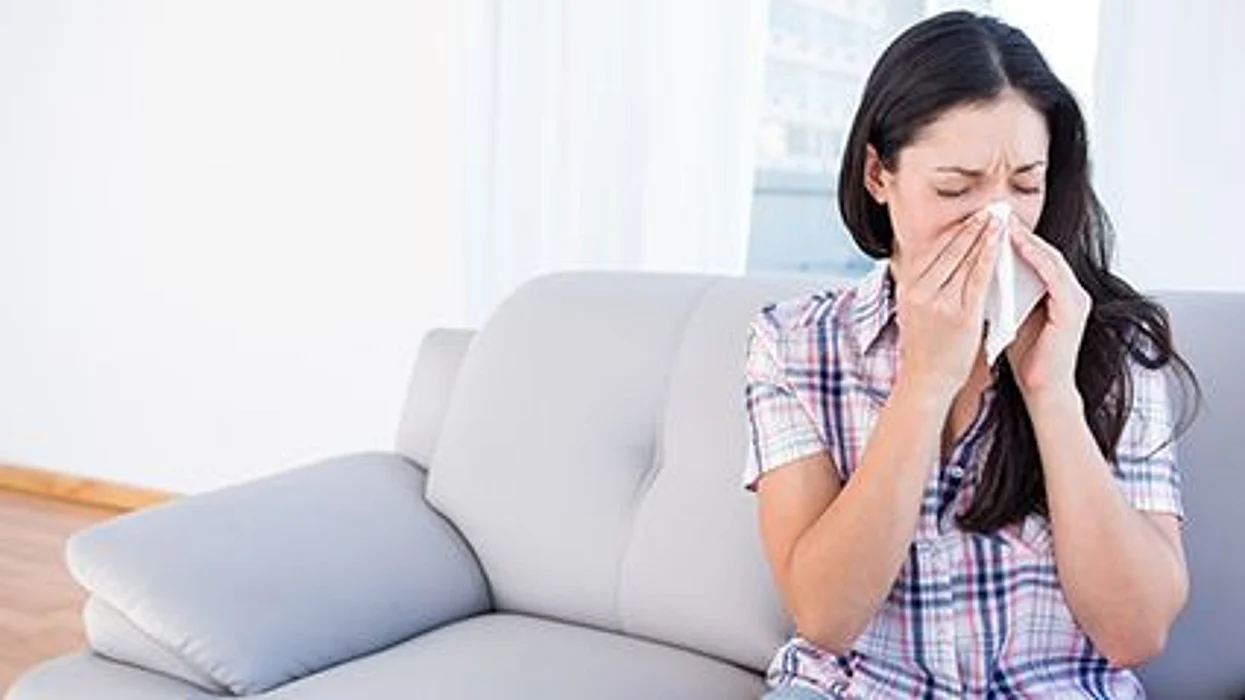 woman blowing her nose