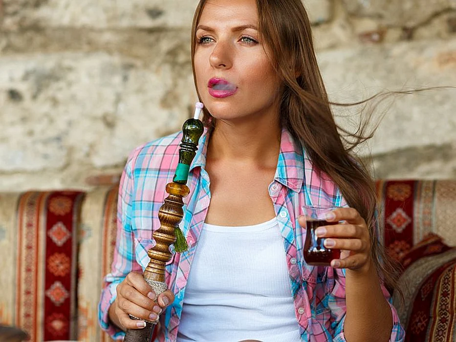 woman using hookah