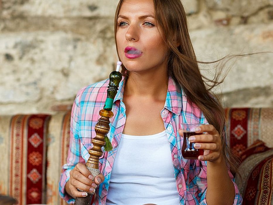 woman using hookah