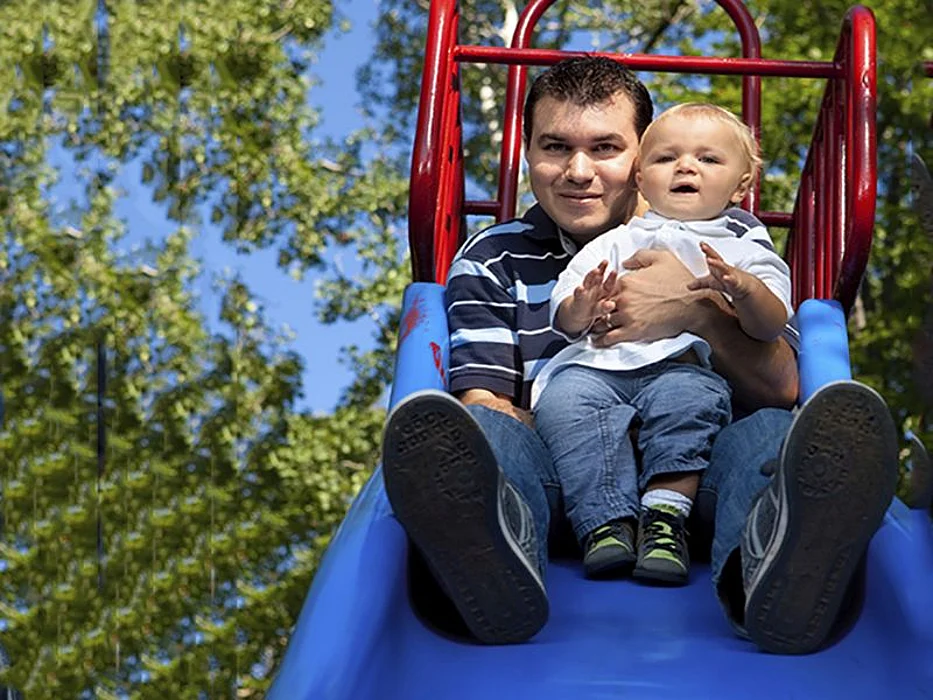 kid sliding with adult