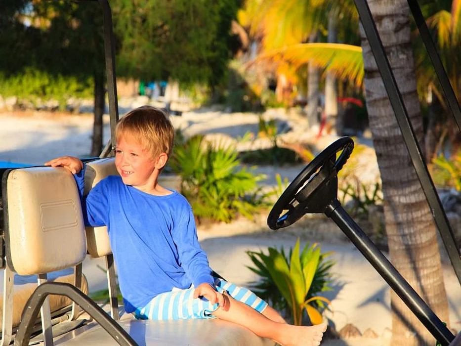 boy driving golf cart