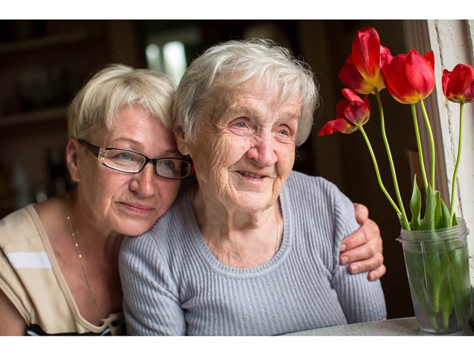 younger woman caring for older woman