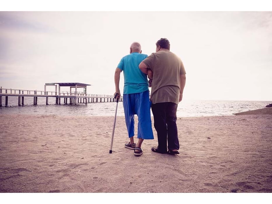 elderly walking on the beach