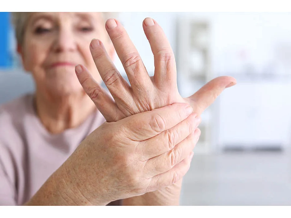 woman holding her hand in pain