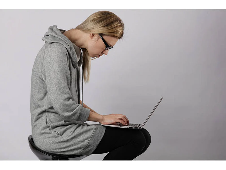 woman slouching while using computer