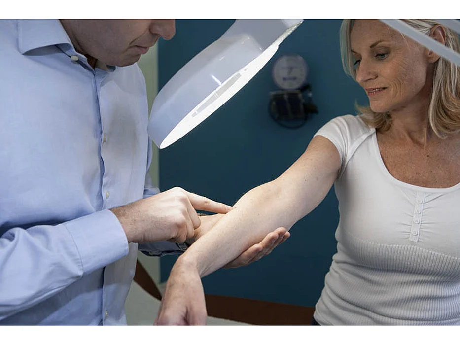 doctor testing woman\'s skin