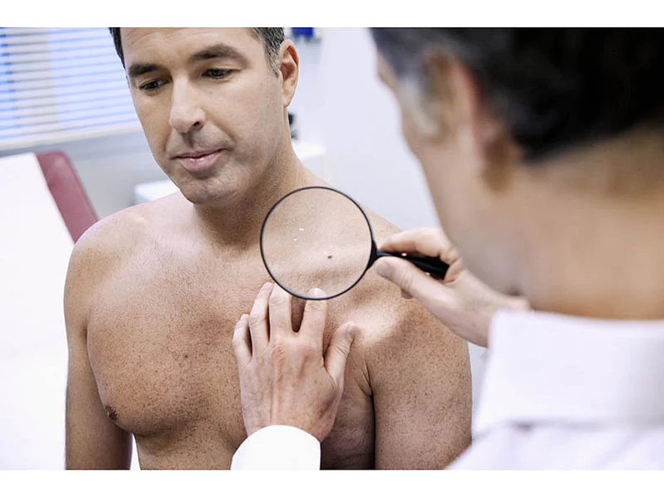 doctor examining patient\'s skin