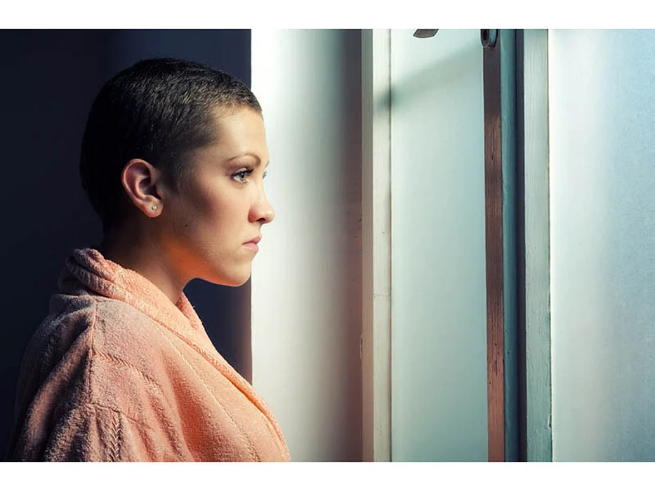 sad woman looking through the window