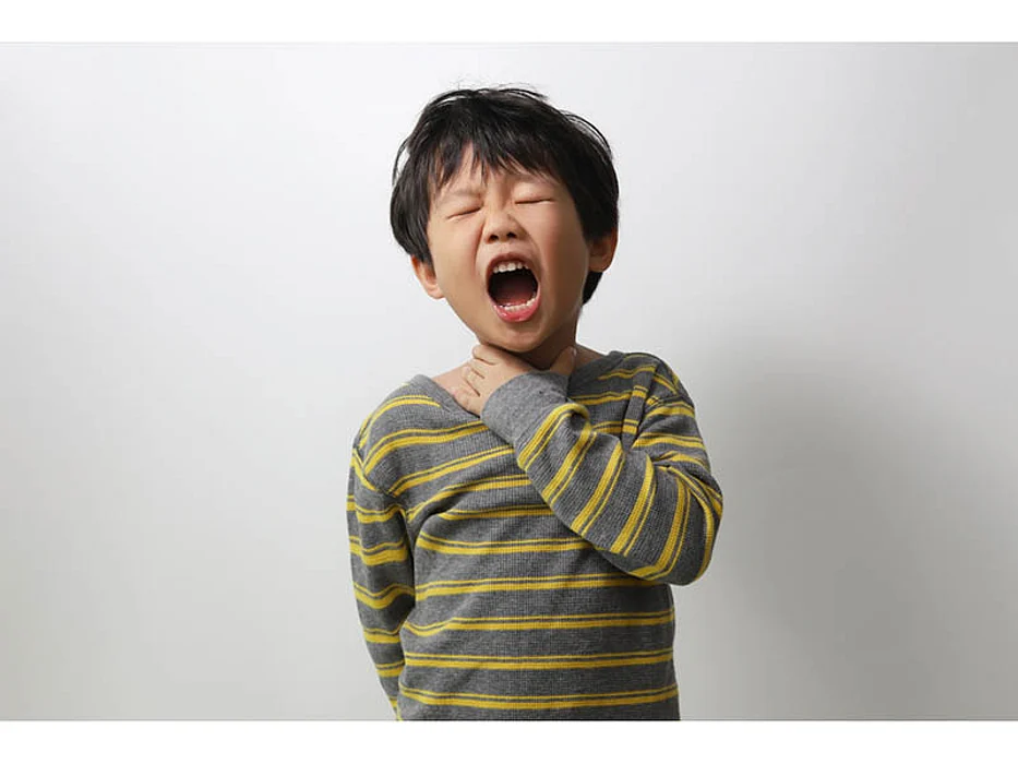 a boy choking holding his throat