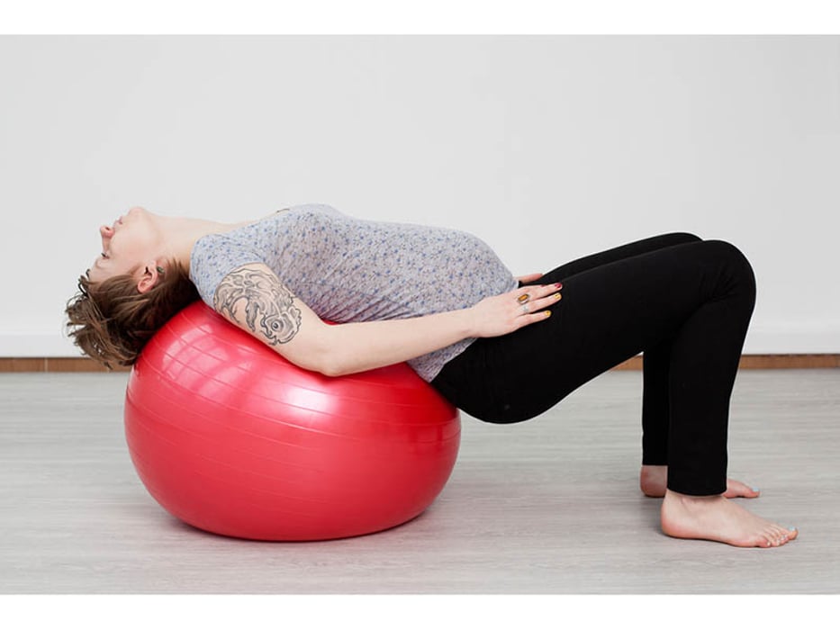 pregnant woman exercising on a ball