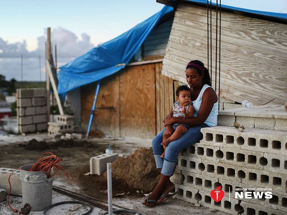 A mother holds her 9-month-old 3 months after Hurricane Maria destroyed her home in Puerto Rico