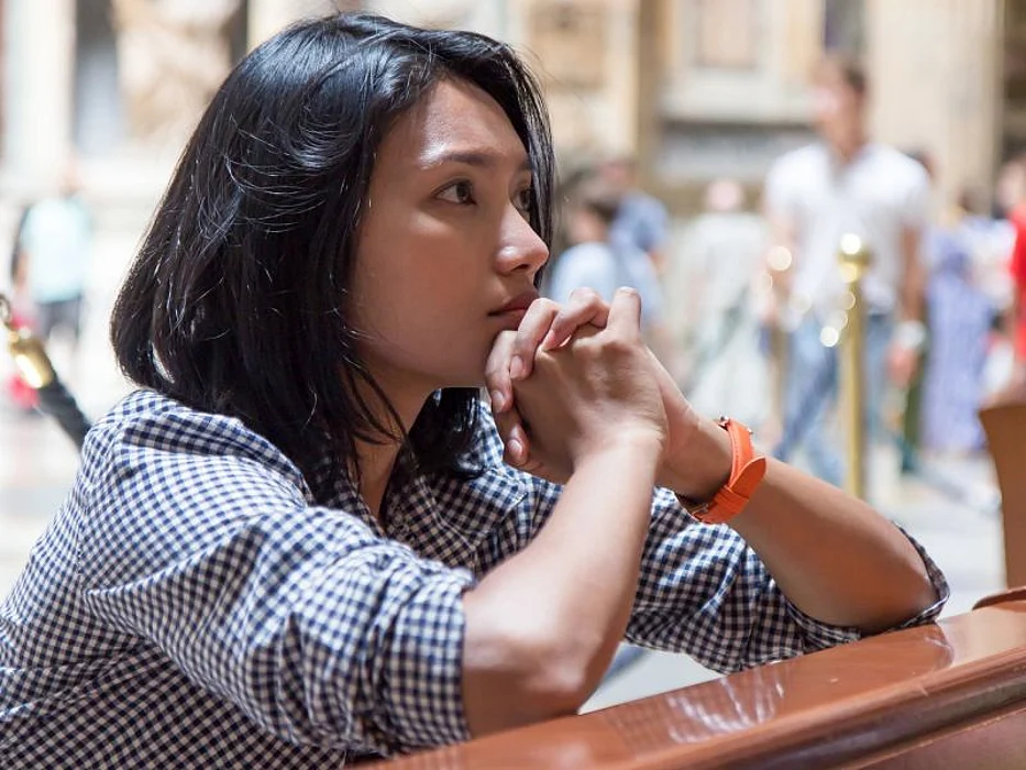 woman praying in church