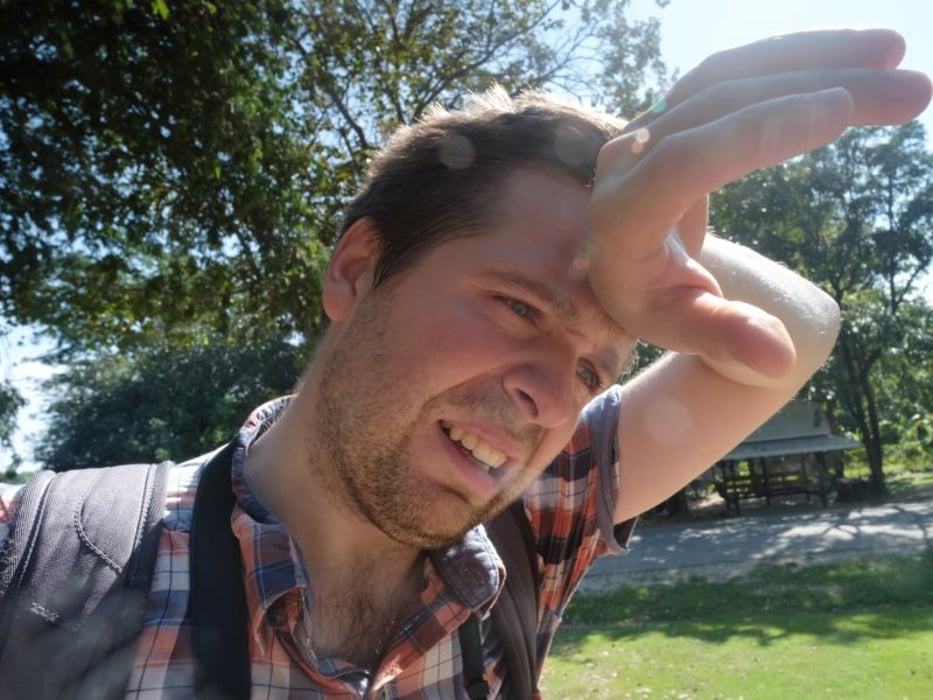 man wiping brow in hot weather
