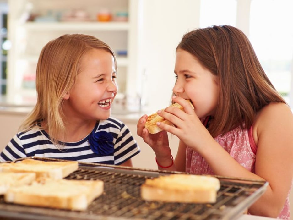 young girls eating bread