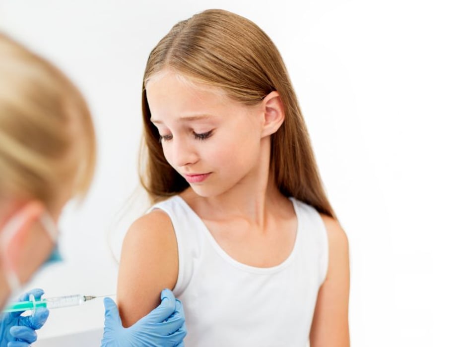 pre-teen girl getting vaccinated