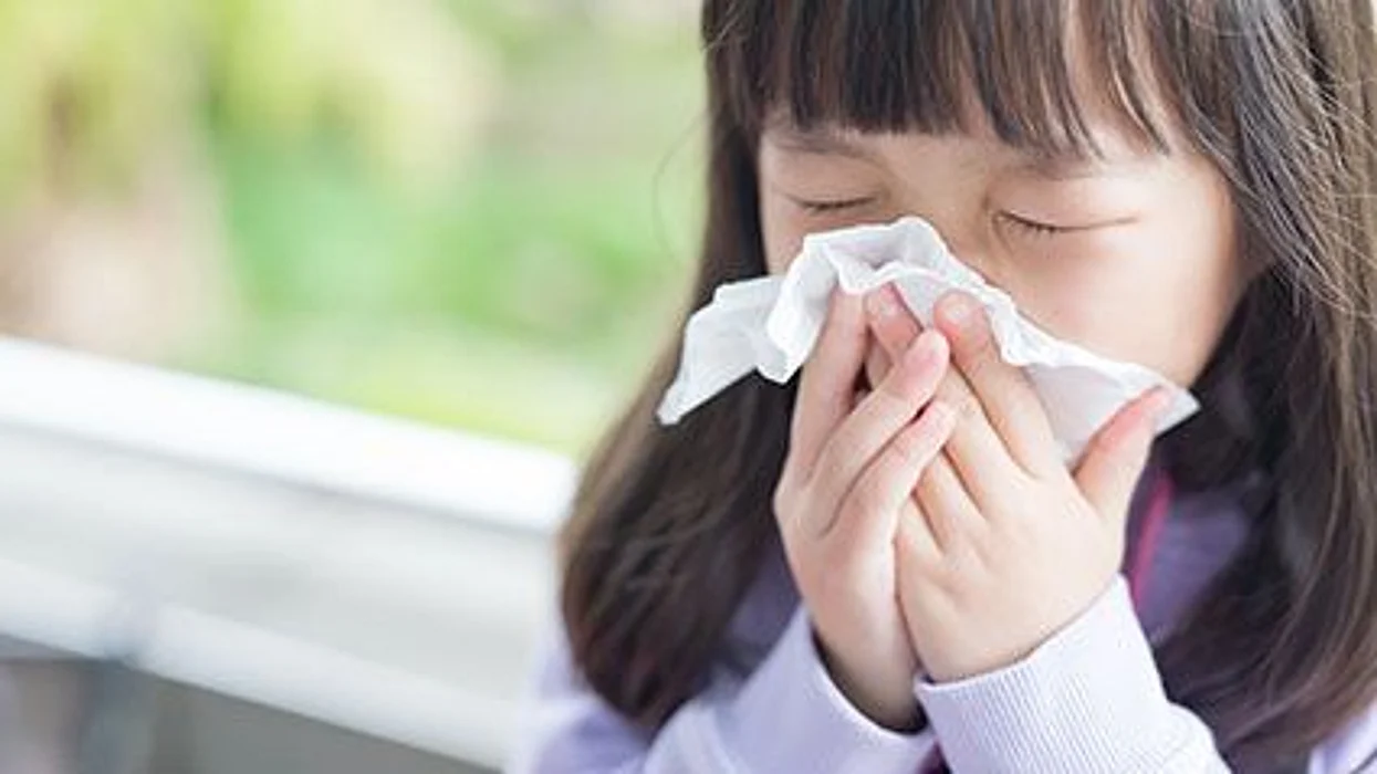 a girl blowing her nose