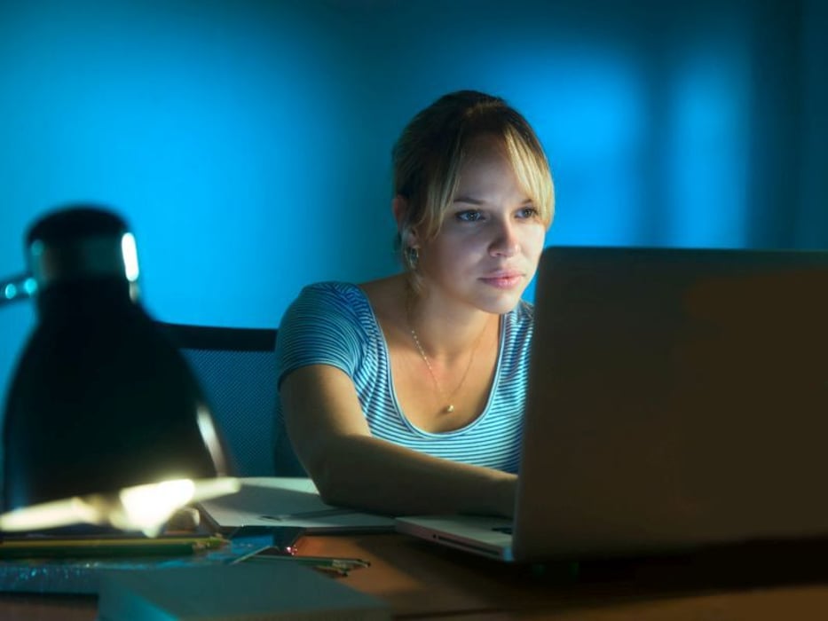 Woman using laptop computer late at night