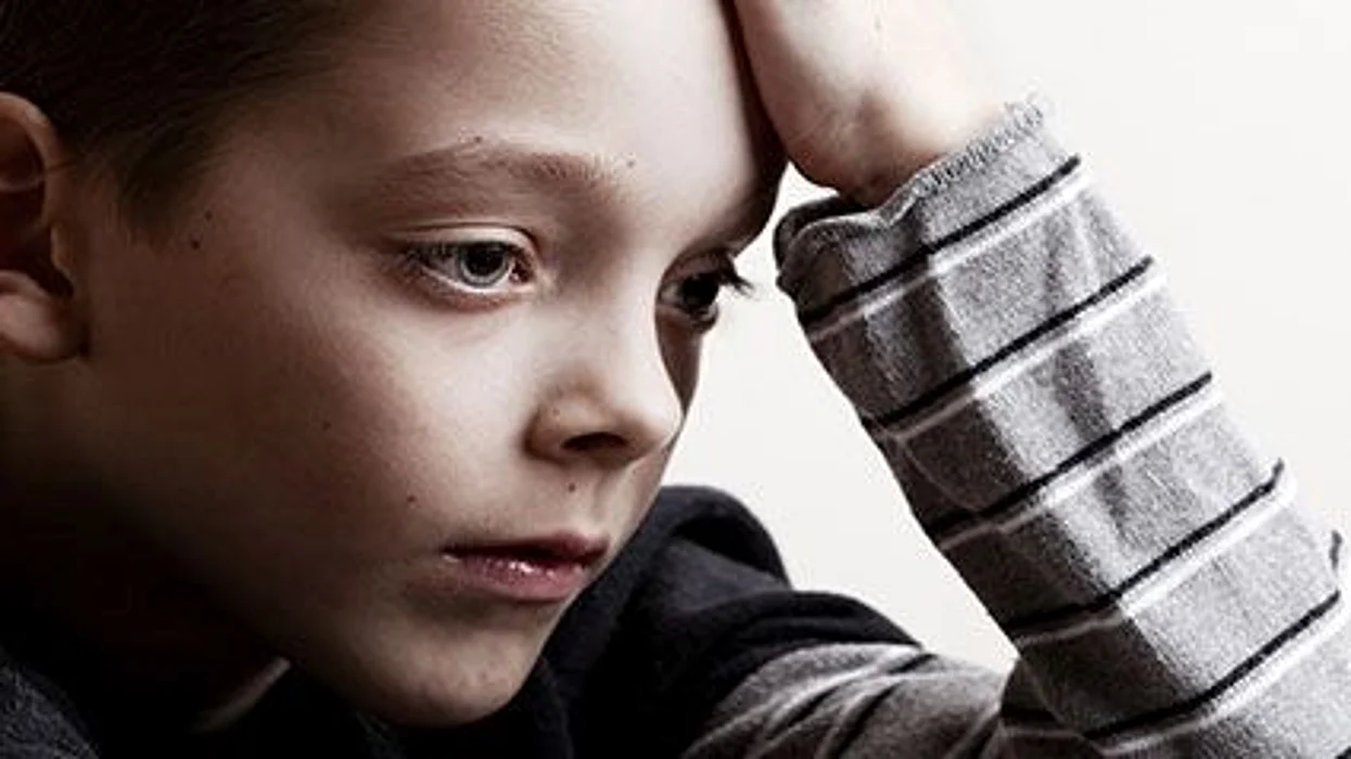 a sad boy\'s face close up