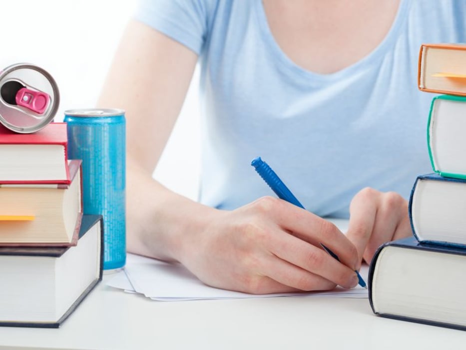 Girl studying while consuming energy drink