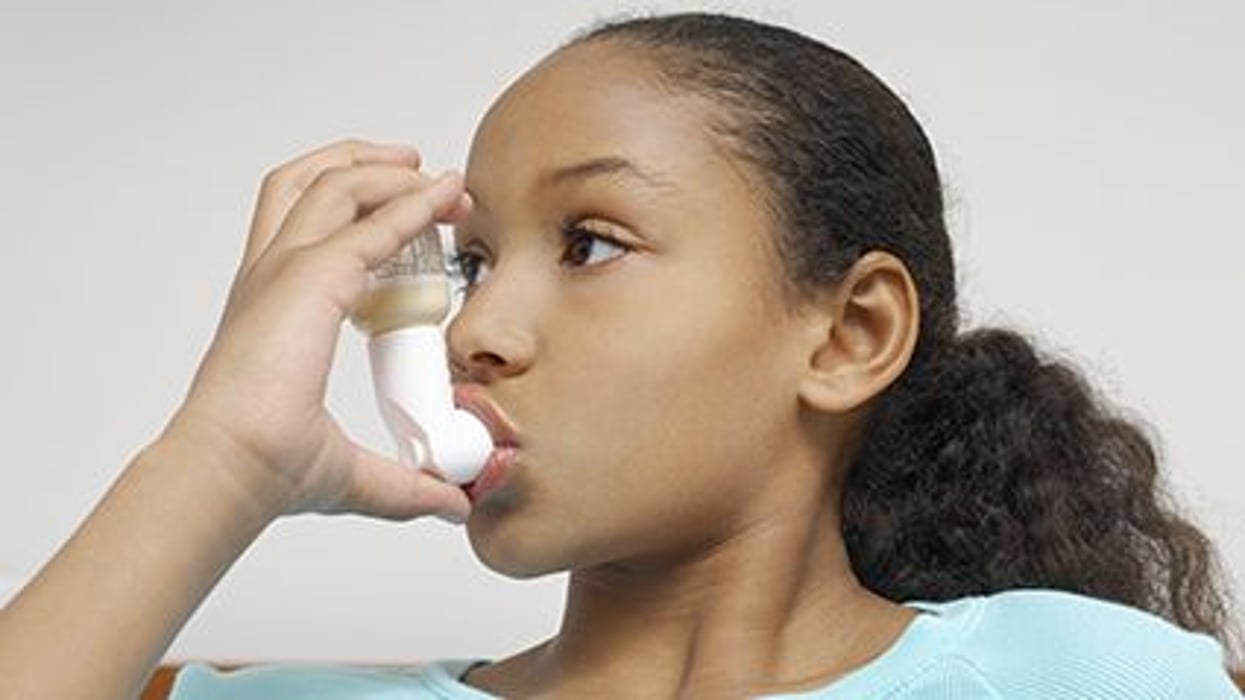 a girl with an asthma inhalator
