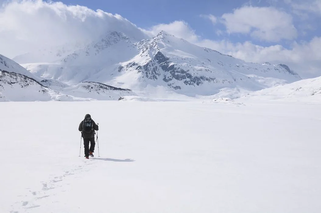 Arctic snowy landscape with a person in parka