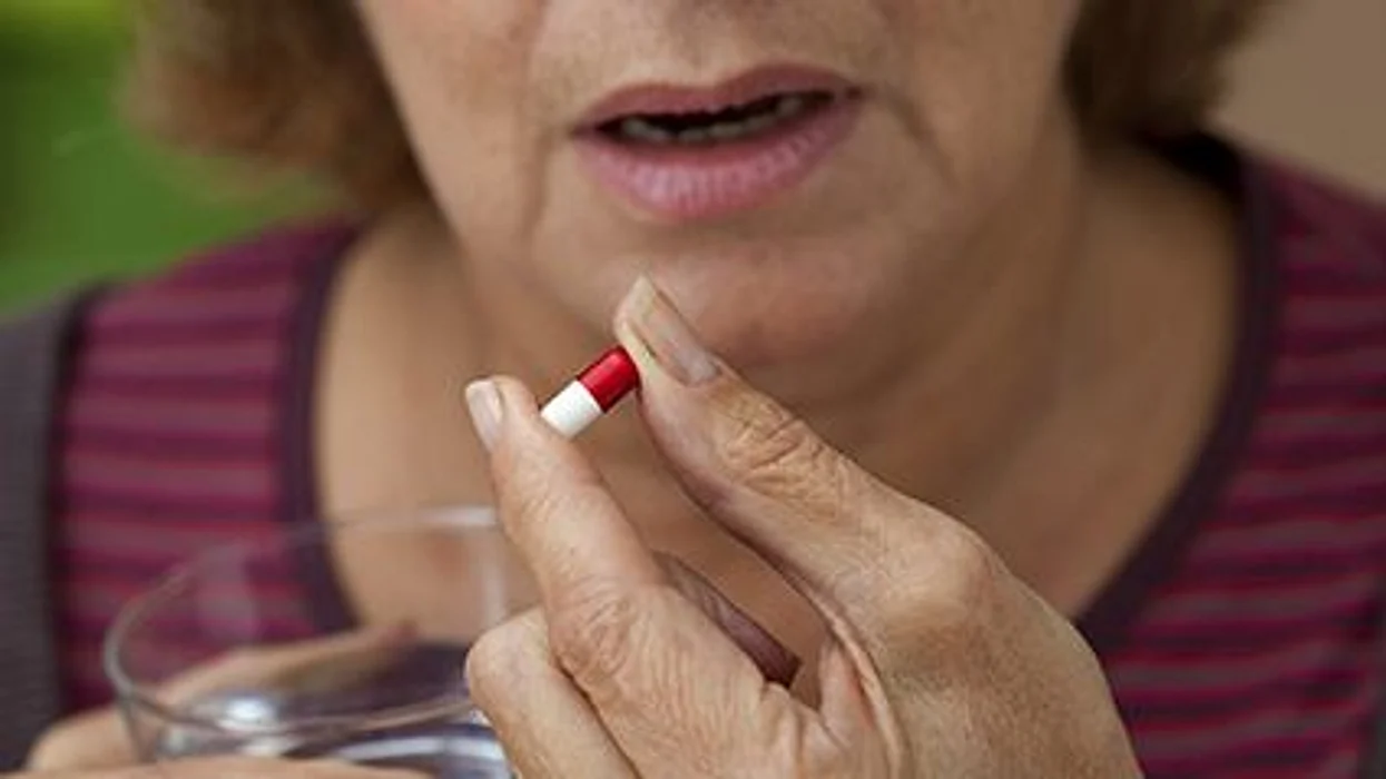 a woman taking pill