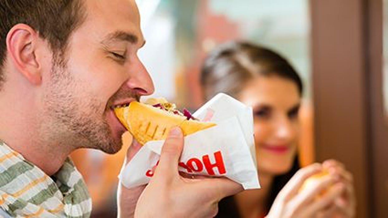 a person eating hot-dog