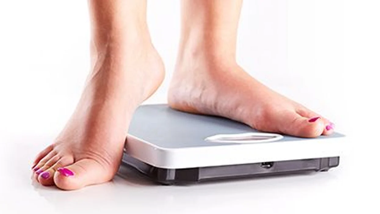 a female\'s feet on a scale