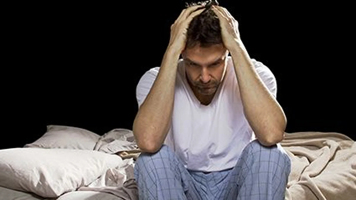 a man holding his head looking stressed