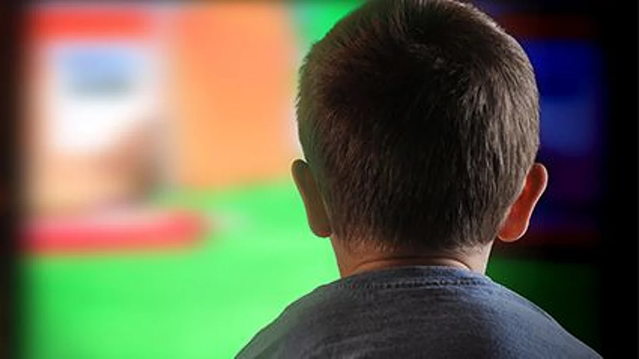 a boy in front of the TV