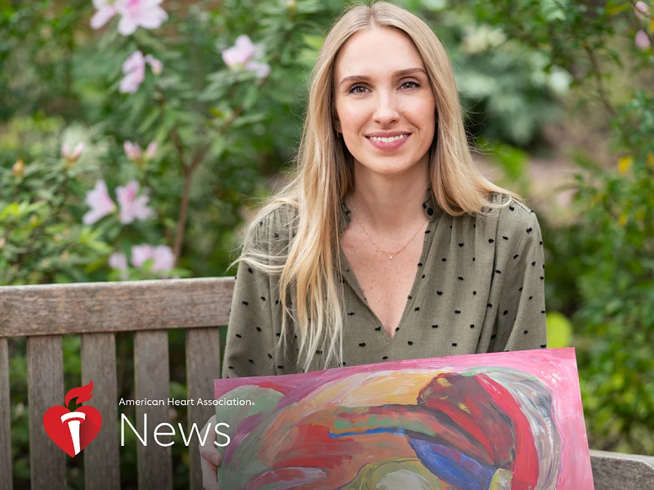 Katie Hinson with a piece of art from Strokes for Strokes