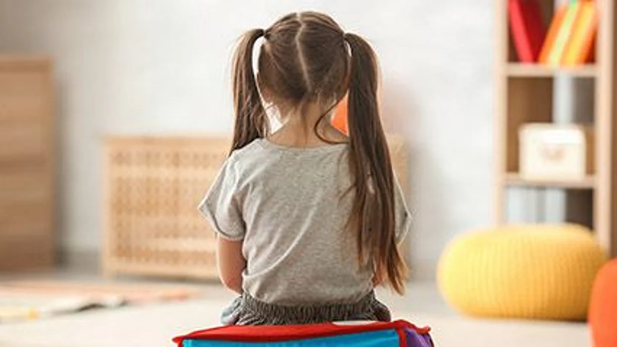 a girl sitting in a room