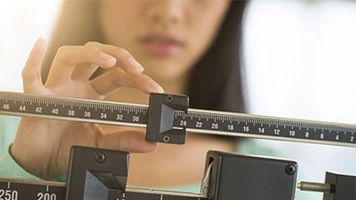 a girl on a scale