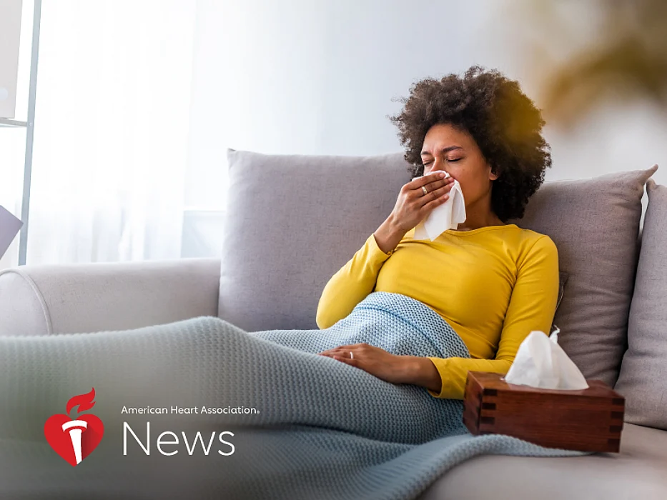 a girl sick in a bed wiping her nose