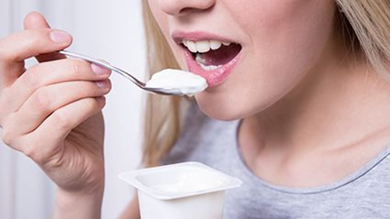 a girl eating with a spoon